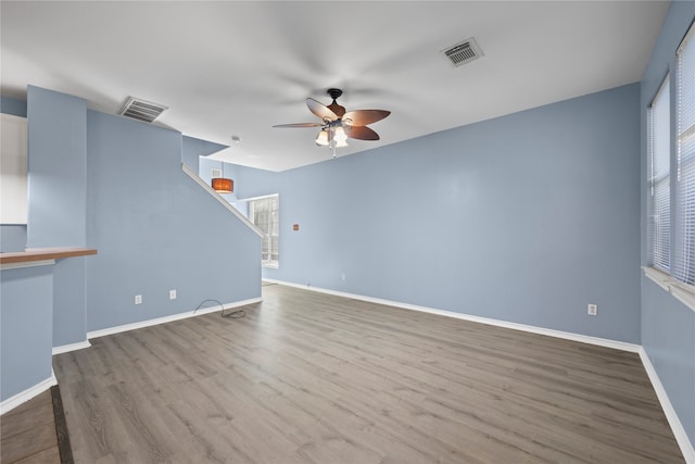 unfurnished living room featuring ceiling fan and wood-type flooring