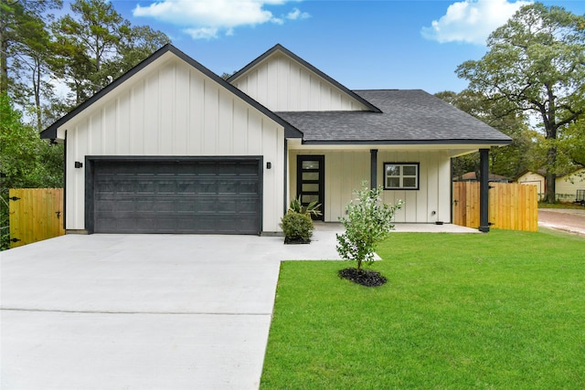 view of front facade with a garage, covered porch, and a front yard