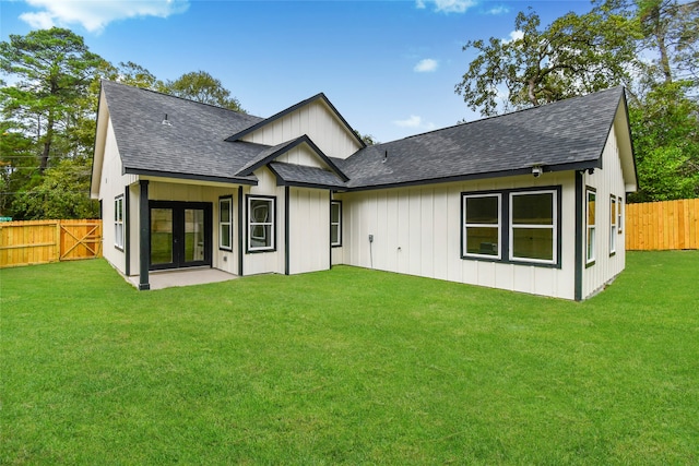 rear view of property featuring a yard and french doors