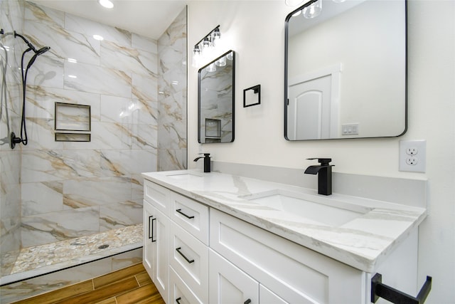 bathroom featuring vanity and tiled shower