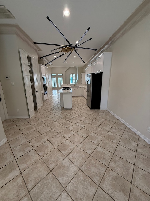 kitchen featuring crown molding, a kitchen island, white cabinets, and an inviting chandelier