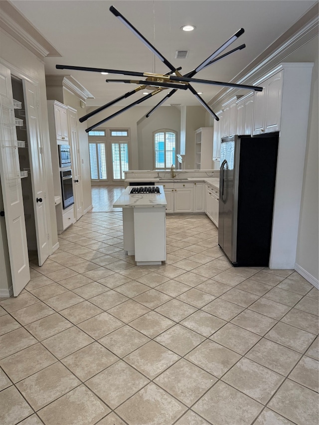 kitchen with white cabinetry, stainless steel appliances, and ornamental molding