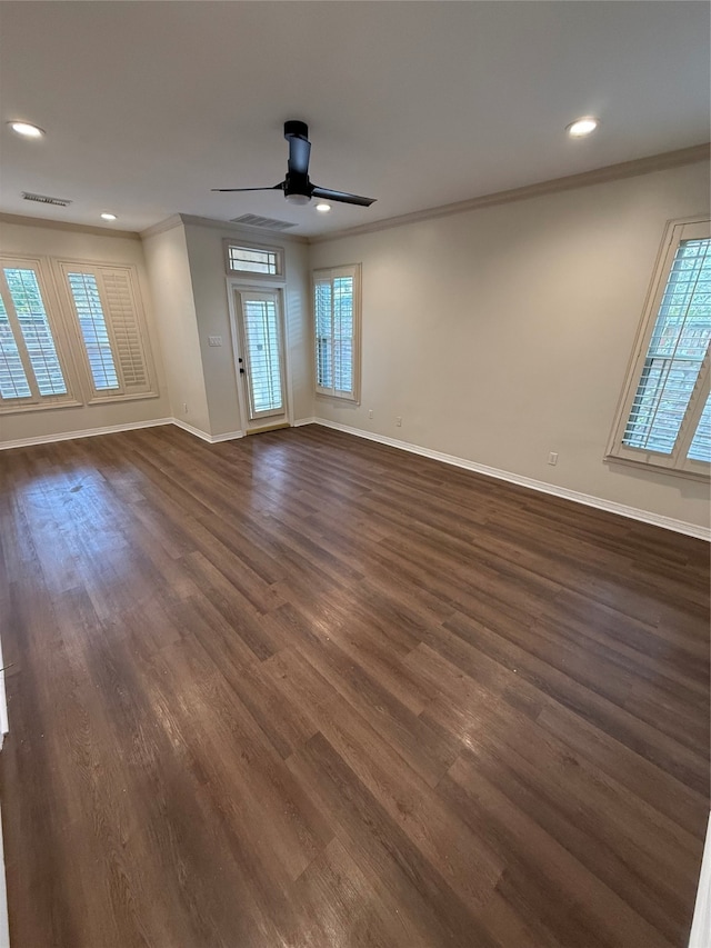 empty room with plenty of natural light and dark hardwood / wood-style floors