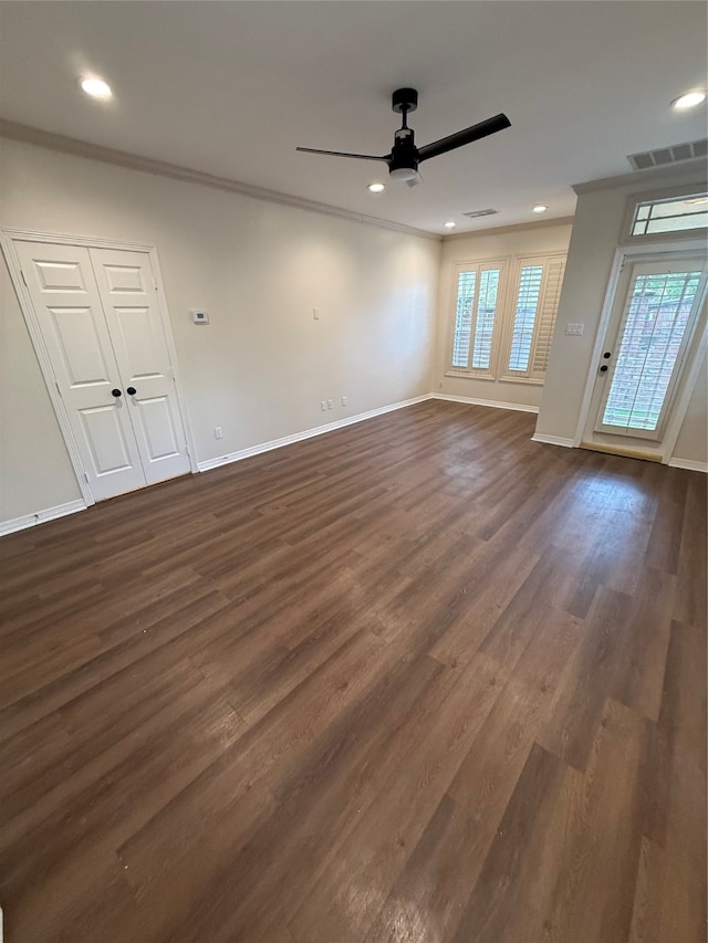 spare room with ceiling fan, ornamental molding, and dark wood-type flooring