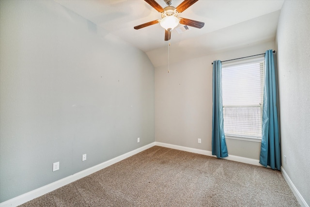 carpeted spare room featuring vaulted ceiling, ceiling fan, and a healthy amount of sunlight