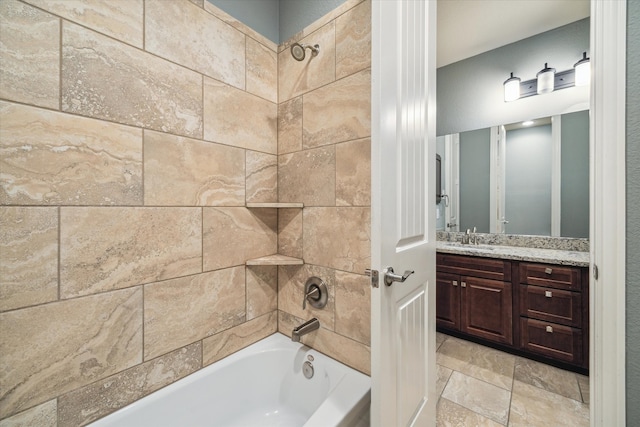 bathroom with vanity and tiled shower / bath