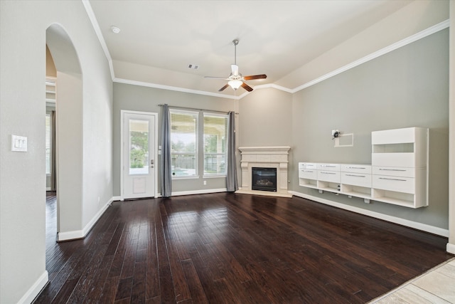 unfurnished living room with ceiling fan, crown molding, and dark hardwood / wood-style floors