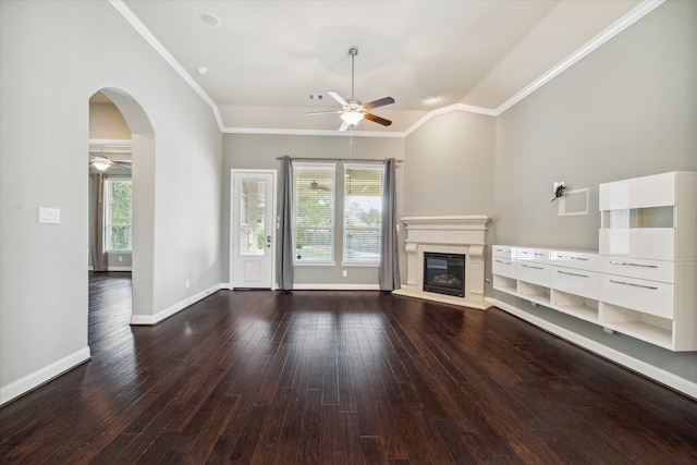 unfurnished living room featuring dark hardwood / wood-style flooring, crown molding, plenty of natural light, and ceiling fan