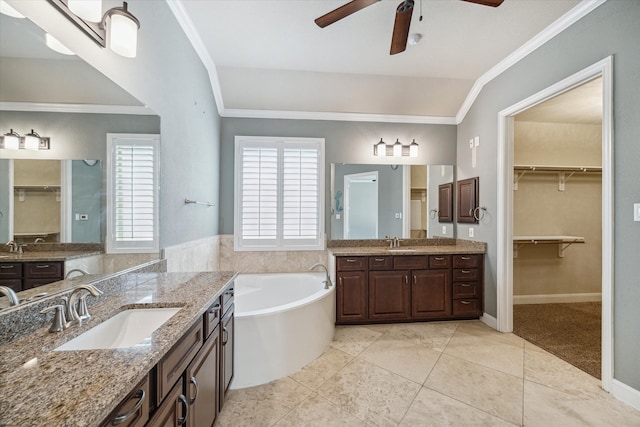 bathroom featuring a bathtub, vanity, vaulted ceiling, ceiling fan, and crown molding