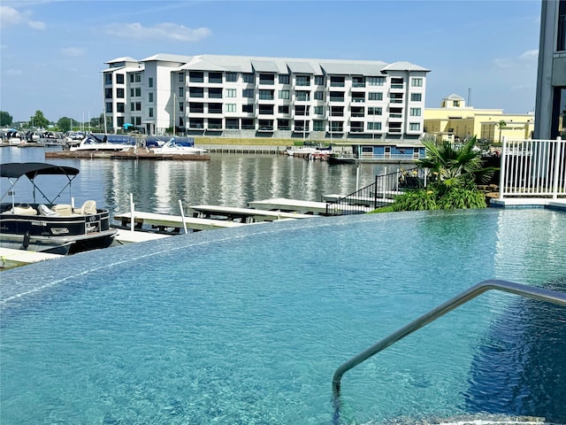 168 Lake Point Blvd Unit A101, Conroe, TX 77356 - view of pool featuring a water view and a boat dock