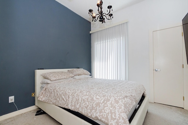 bedroom with light carpet and a notable chandelier