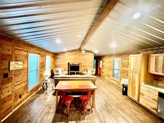 playroom with lofted ceiling with beams, light hardwood / wood-style flooring, and wooden walls