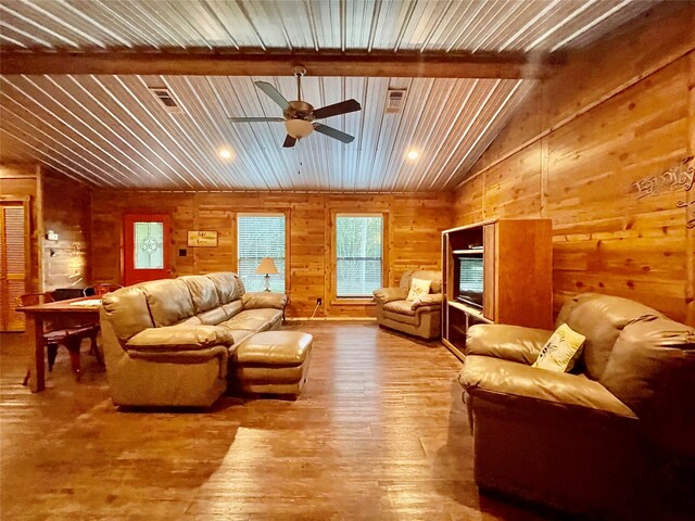 living room with ceiling fan, vaulted ceiling with beams, wood walls, wood-type flooring, and wood ceiling