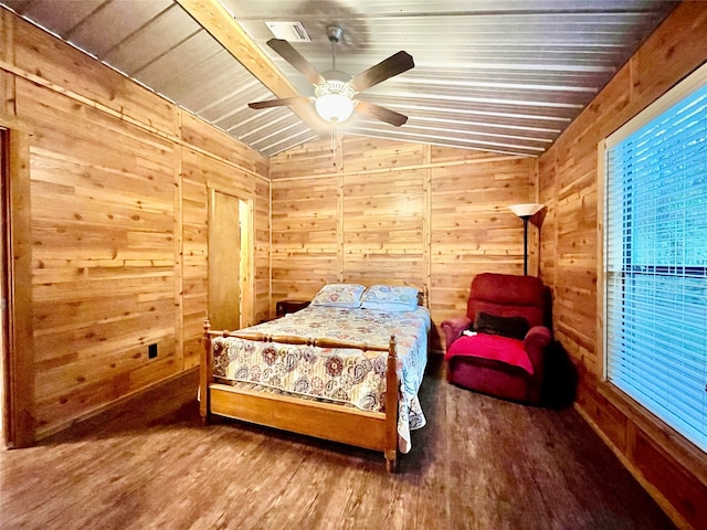 bedroom featuring ceiling fan, wood walls, wood-type flooring, and vaulted ceiling