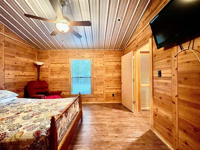 bedroom with ceiling fan, wood-type flooring, lofted ceiling, wooden walls, and wood ceiling