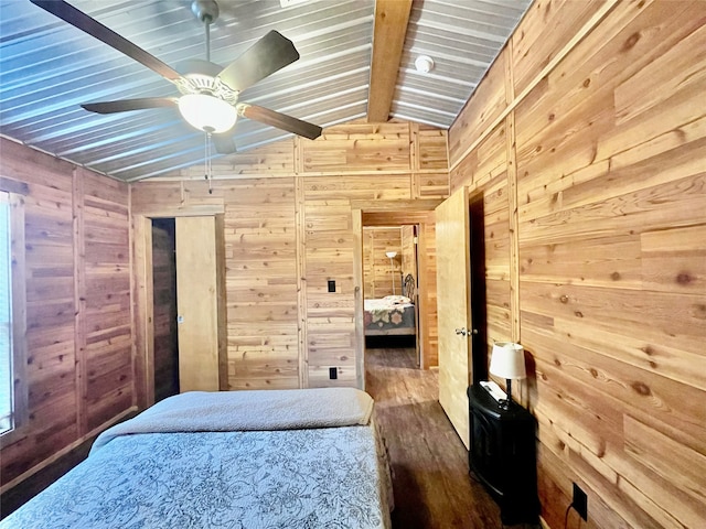 bedroom featuring vaulted ceiling with beams, dark hardwood / wood-style flooring, and wooden walls