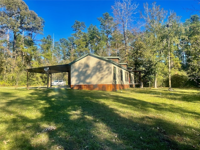 view of side of home with a yard and a carport