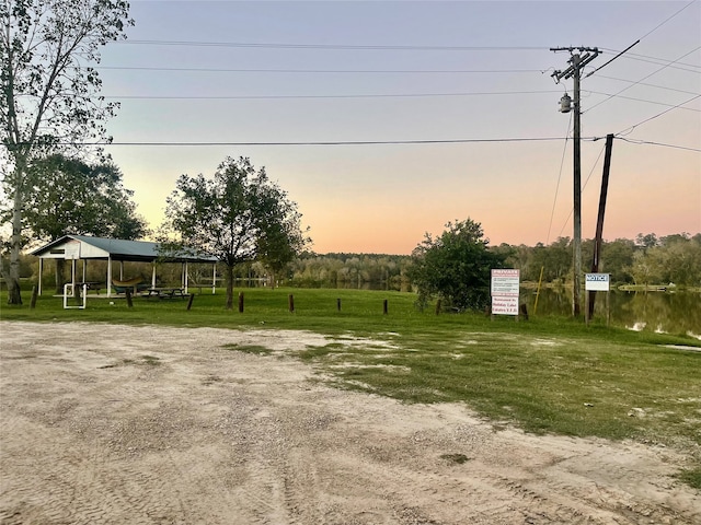 yard at dusk featuring a gazebo