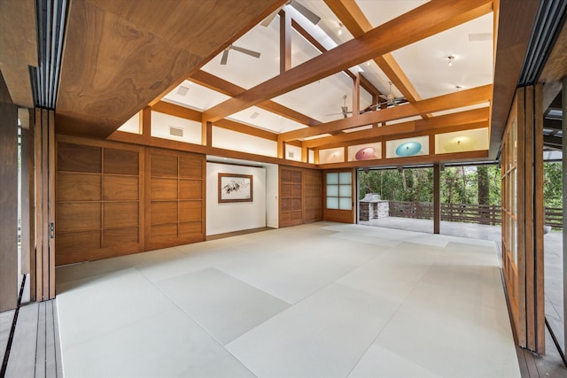 interior space featuring plenty of natural light and lofted ceiling with beams