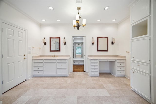 bathroom with vanity, ornamental molding, and a notable chandelier