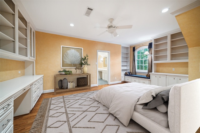 bedroom with ceiling fan, light hardwood / wood-style floors, ornamental molding, and connected bathroom