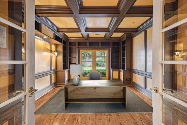 living area featuring french doors, coffered ceiling, crown molding, beamed ceiling, and hardwood / wood-style floors