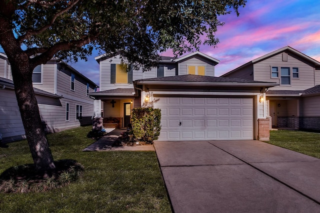 view of front of home with a lawn and a garage