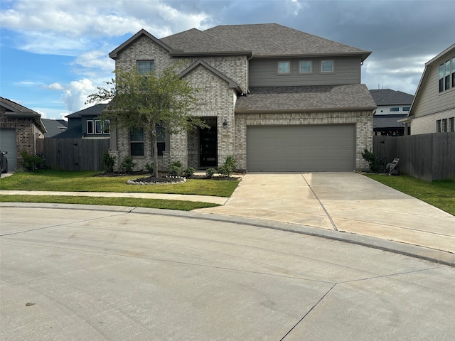 view of front of home with a front yard and a garage