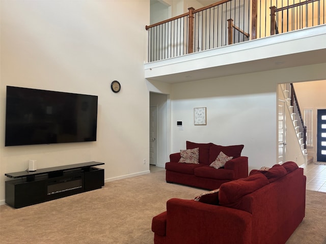 living room featuring carpet and a towering ceiling