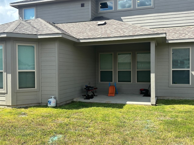 back of property featuring a lawn and a patio area