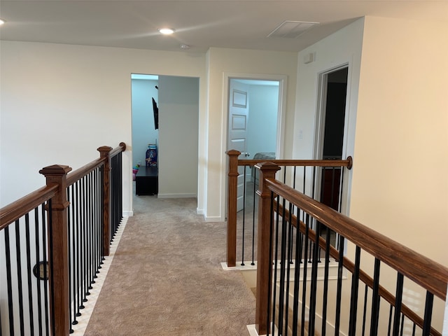 hall featuring light colored carpet