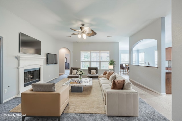 tiled living room with ceiling fan