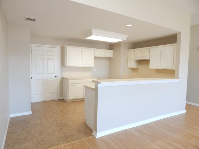 kitchen featuring white cabinetry and light hardwood / wood-style flooring