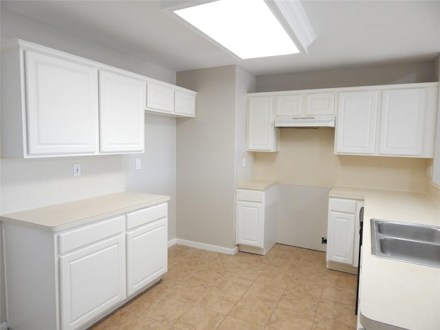 kitchen featuring sink and white cabinetry