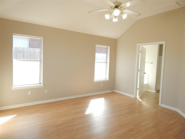 unfurnished room featuring ceiling fan, light wood-type flooring, and vaulted ceiling