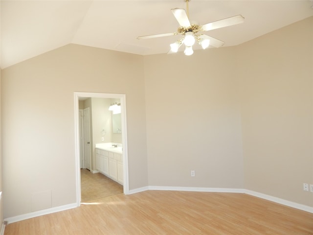 unfurnished room with sink, vaulted ceiling, ceiling fan, and light hardwood / wood-style floors