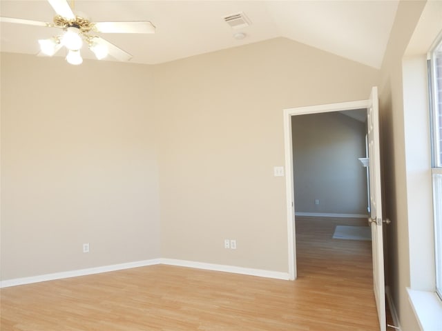 empty room featuring ceiling fan, vaulted ceiling, and light hardwood / wood-style flooring