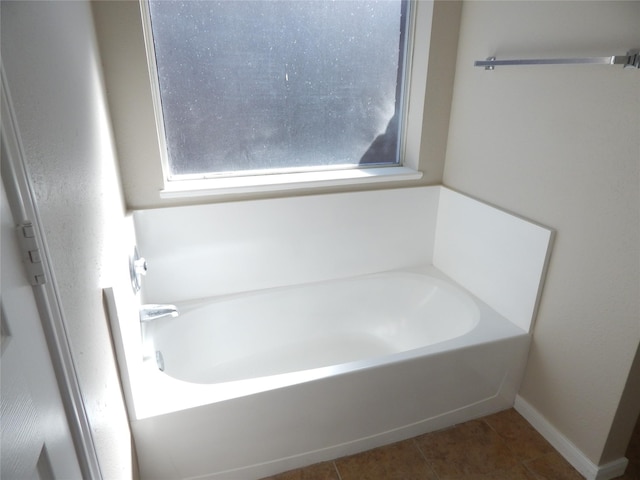 bathroom with tile patterned floors and a bathing tub