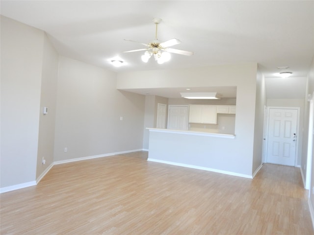 unfurnished living room featuring light wood-type flooring and ceiling fan