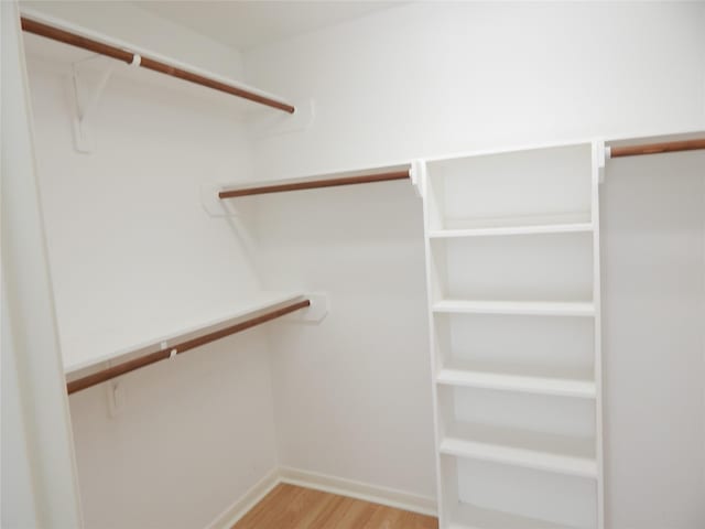 walk in closet featuring light hardwood / wood-style flooring