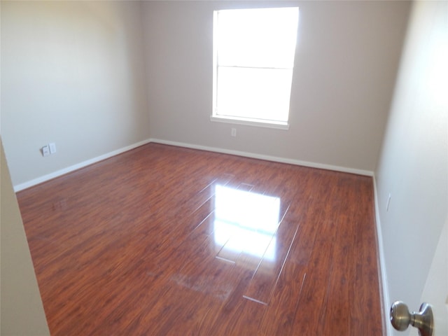 unfurnished room featuring dark wood-type flooring