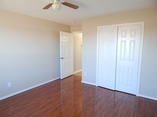 unfurnished bedroom featuring ceiling fan, dark hardwood / wood-style flooring, and a closet