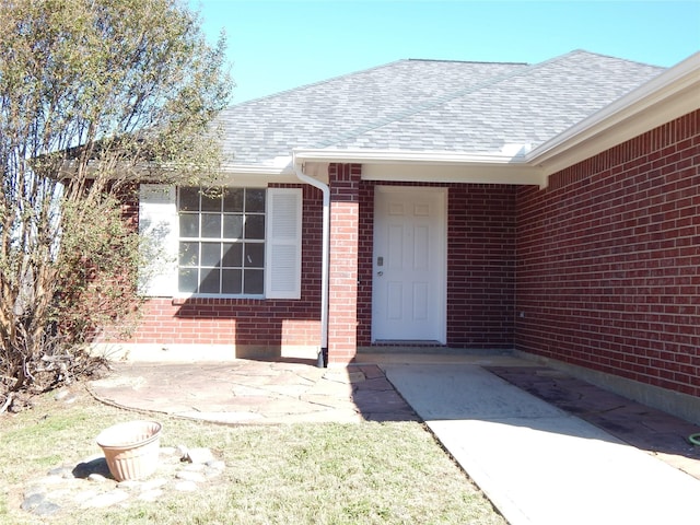 view of exterior entry featuring a patio area