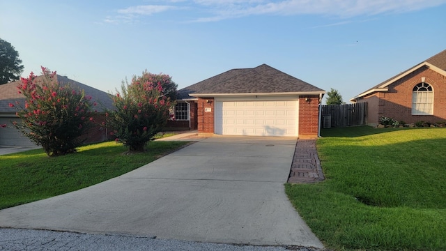 ranch-style home with a front lawn and a garage