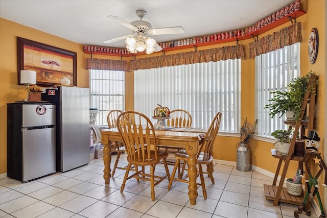 dining space featuring plenty of natural light, ceiling fan, and light tile patterned floors