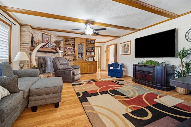 living room featuring a textured ceiling, ceiling fan, crown molding, beam ceiling, and hardwood / wood-style flooring