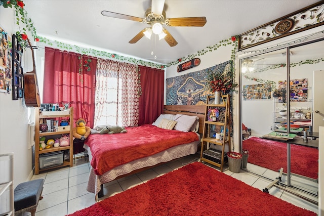 tiled bedroom featuring ceiling fan