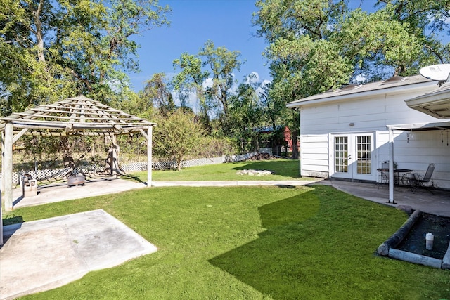 view of yard featuring a gazebo, a patio area, and french doors