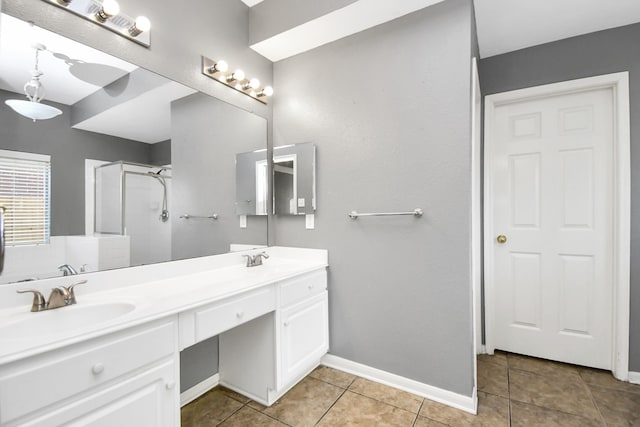 bathroom featuring tile patterned floors, vanity, and a shower with shower door