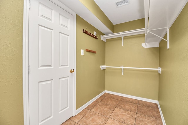 spacious closet featuring light tile patterned flooring